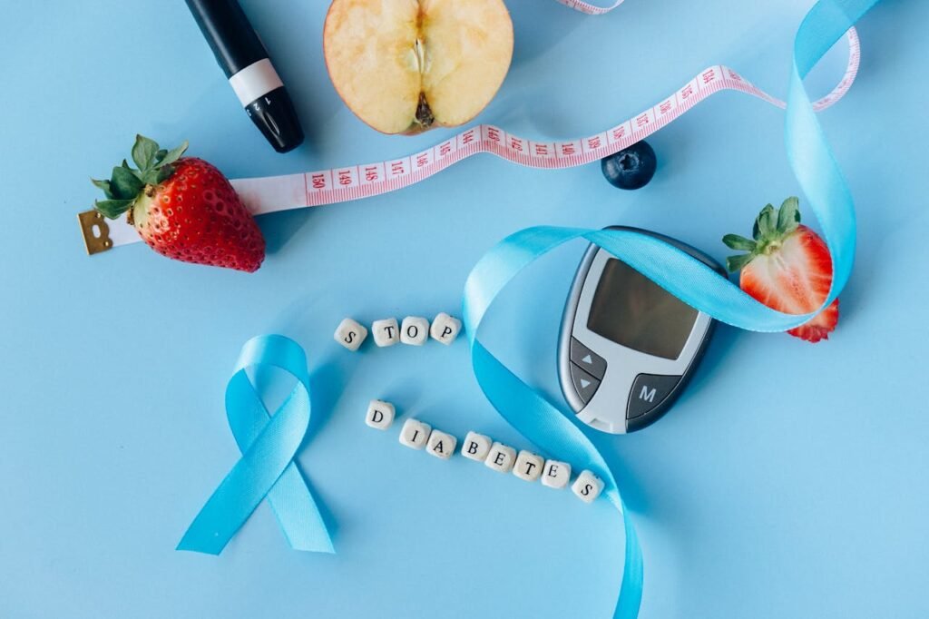 pexels photo 6942085 Creative diabetes awareness with fruits, glucometer, and ribbon on blue background.